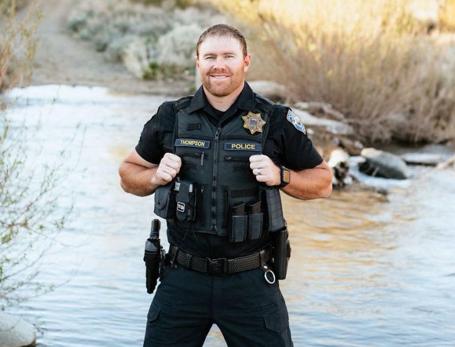 Officer Michael Thompson in police uniform, smiling in front of a river. 