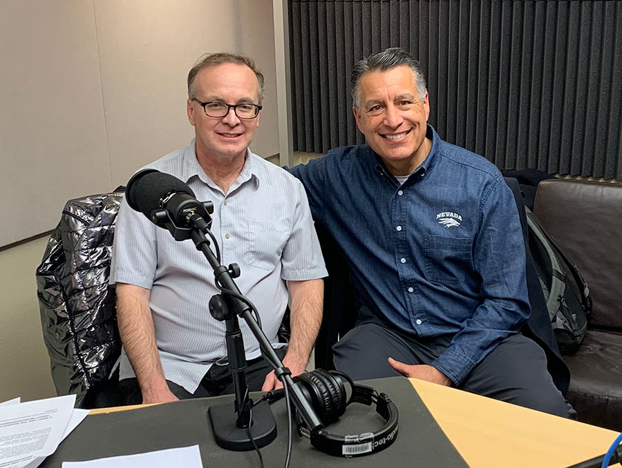 President Sandoval sits to the right of Jeffrey Hutsler in a podcast recording room.