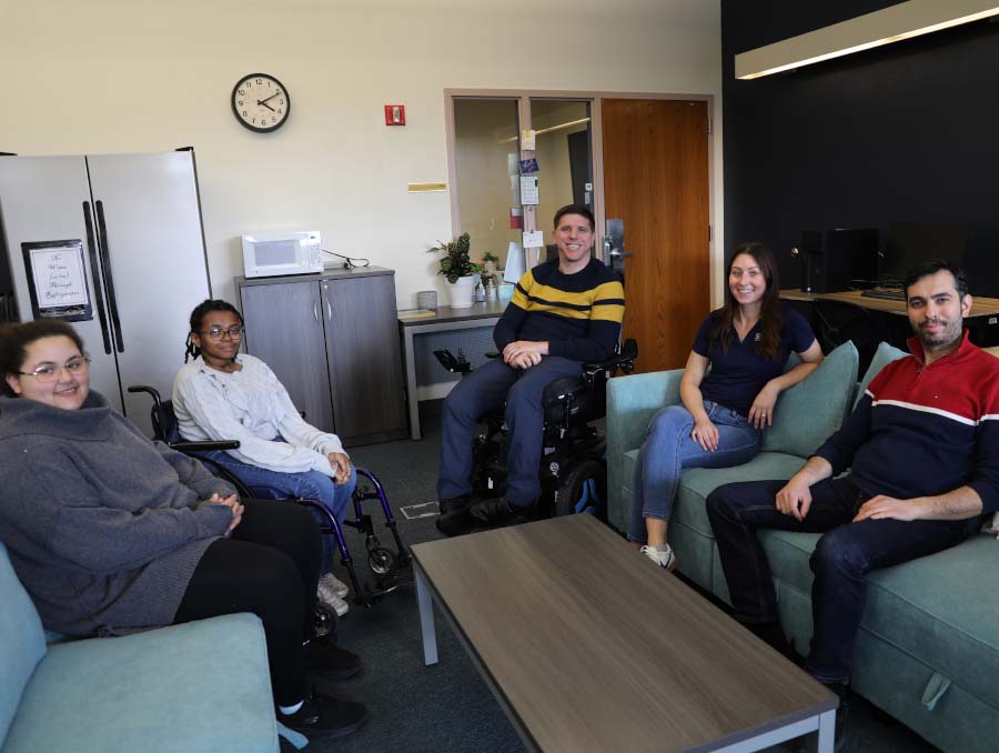 Makaalynn Wortham, Ammal Abdul, Randal Owen, Nicole Wadden and Mehmet Gumus sitting on a couch and smiling