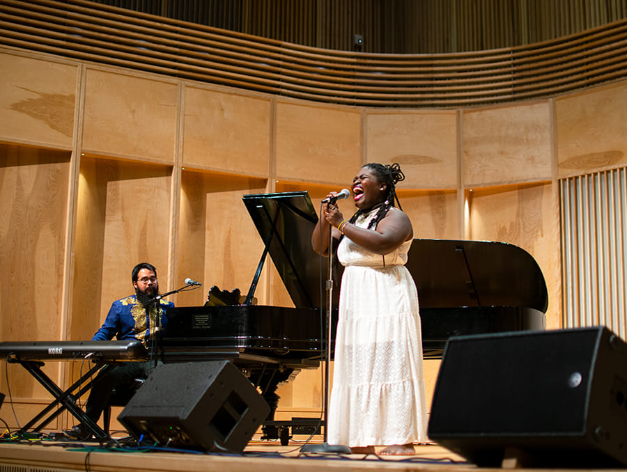 Cuban musician Daymé Arocena singing on stage at the University of Nevada, Reno.