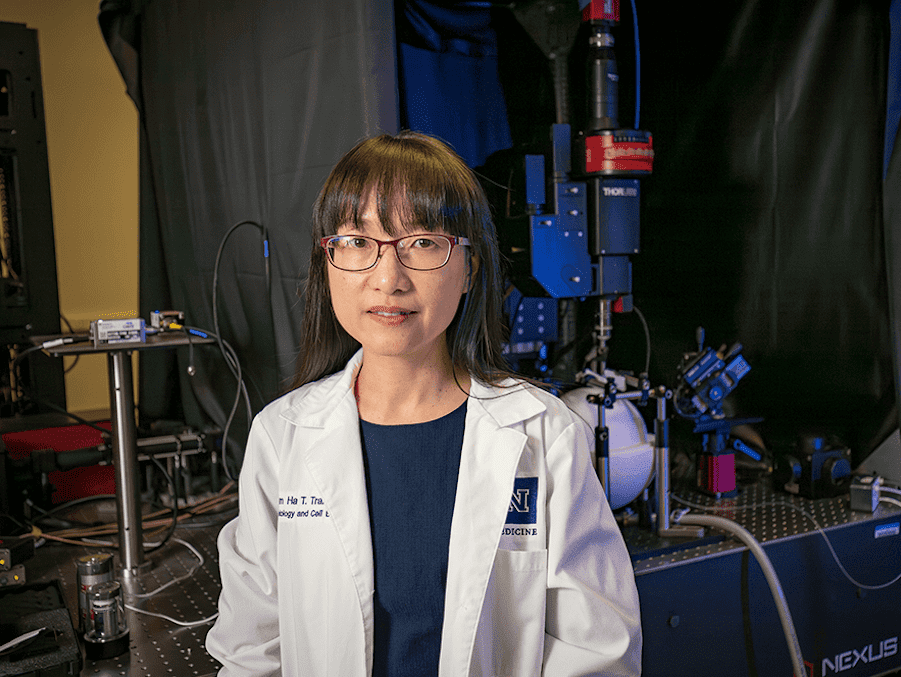 Dr. Cam H Tran in the lab with a white lab coat on