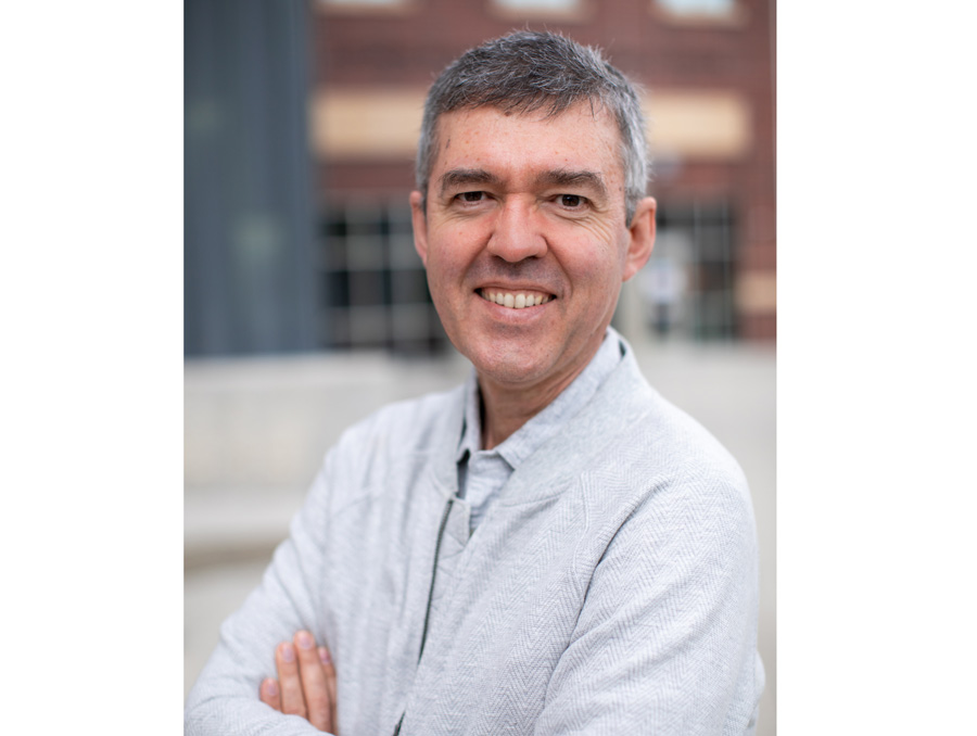 A portrait of Ilya Zaliapin smiling outside of the Davidson Mathematics and Science Center.