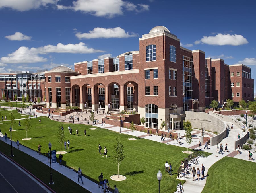 Arial shot of the University campus with a blue sky and sparse white clouds in the background. 