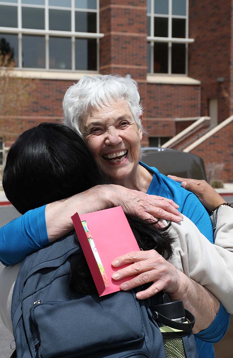 Joy Crowley hugging a student