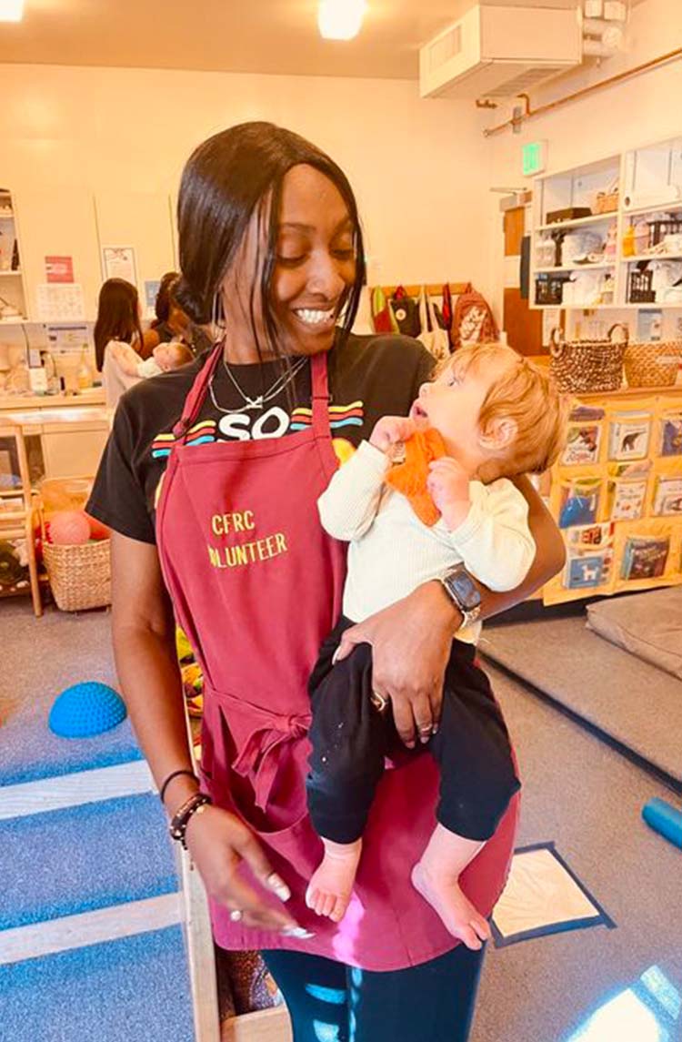 Kiara Lee Moffett holding a baby