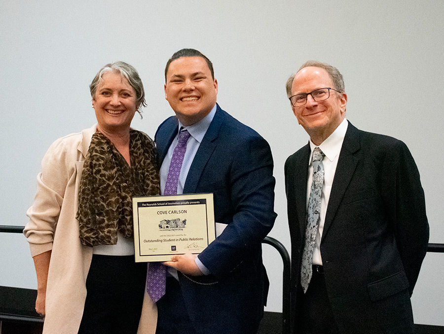 Alison Gaulden and Dean Al Stavitsky presenting an award to student Cove Carlson.