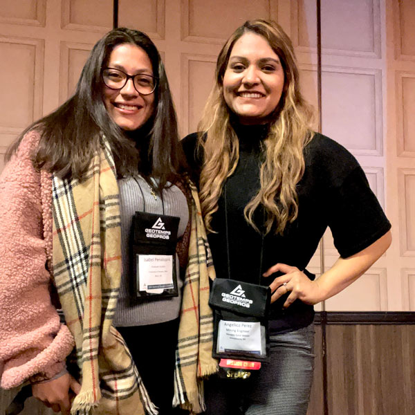 Isabel Penaloza and Angelica Perez smile with their arms around one another.