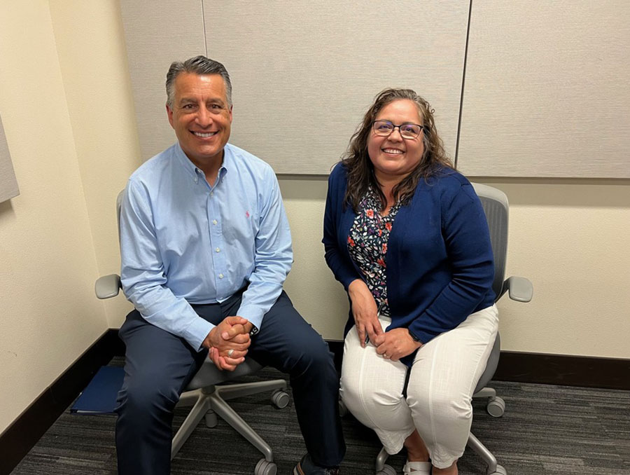 President Brian Sandoval sits next to Daphne Emm - Hooper in the podcasting room at the Reynold's School of Journalism.
