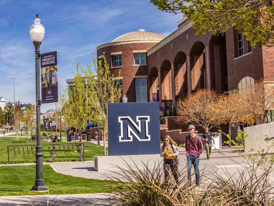 The University campus near the Knowledge Center with the N monument and students walking.