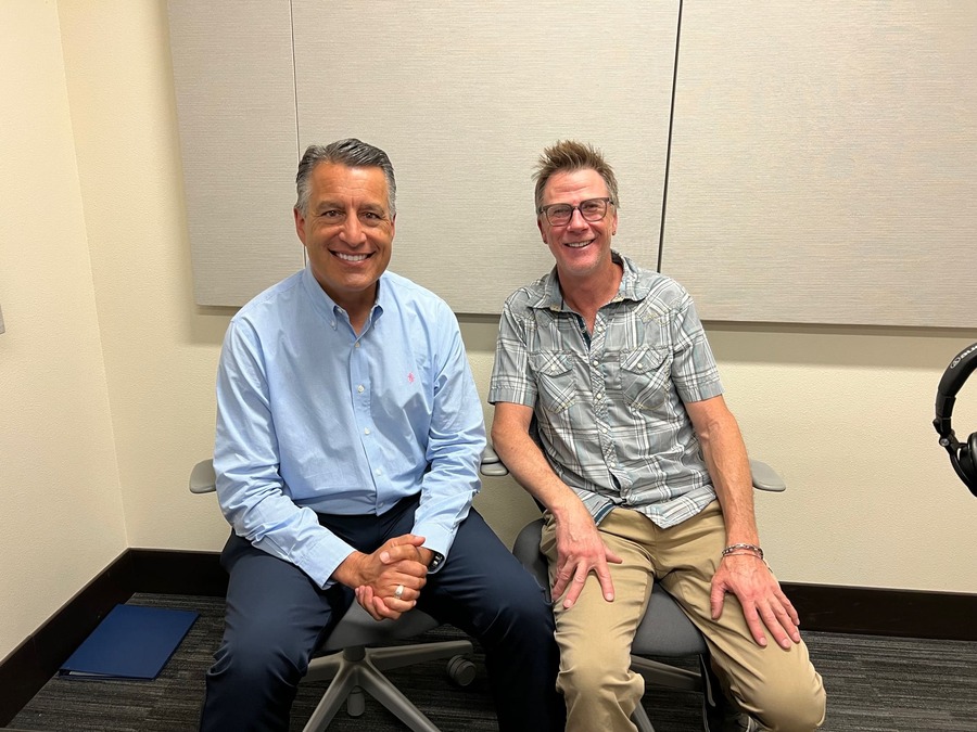 President Brian Sandoval sits next to Rick Parsons in the podcasting room at the Reynold's School of Journalism.