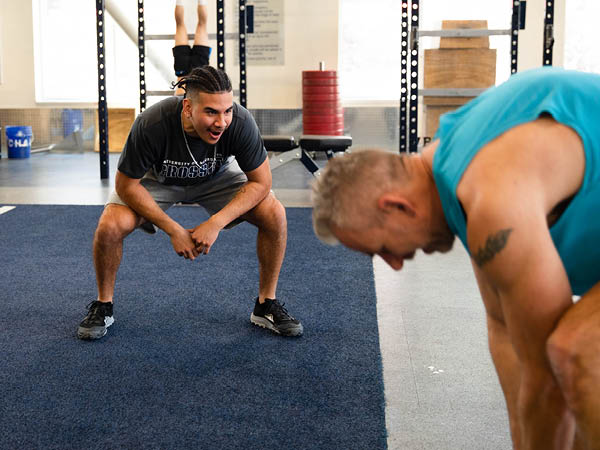 Angel Barboza encourages student during a fitness class