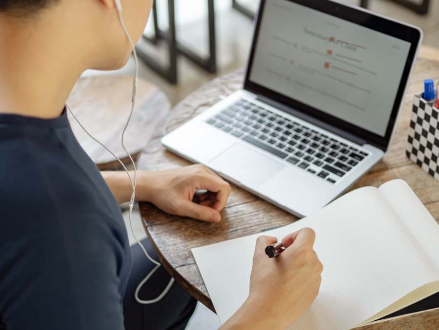 A person with a laptop and notepad