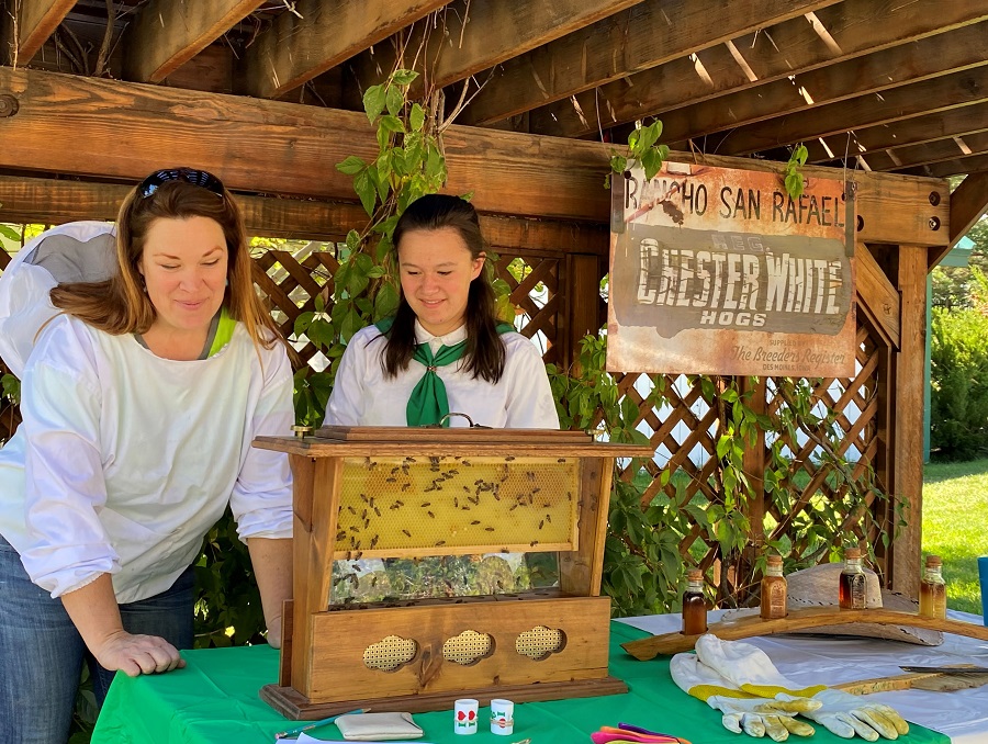 4-H club leader Marie and member Keira share a beekeeping project.