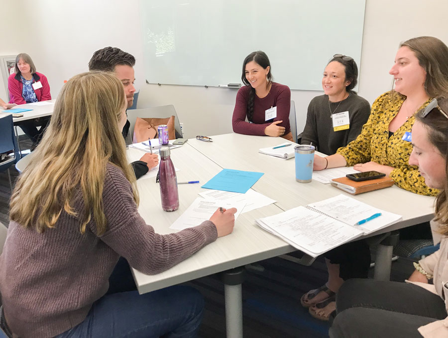 A group discussion happens at a table