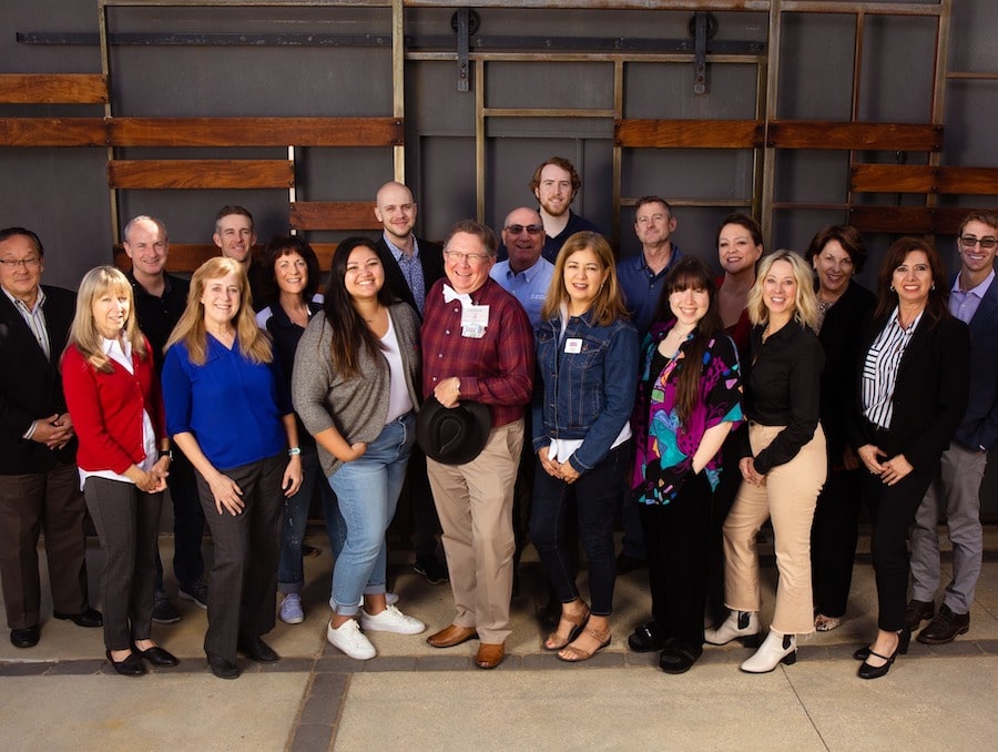 19 staff members of the Nevada SBDC pose together as a group.