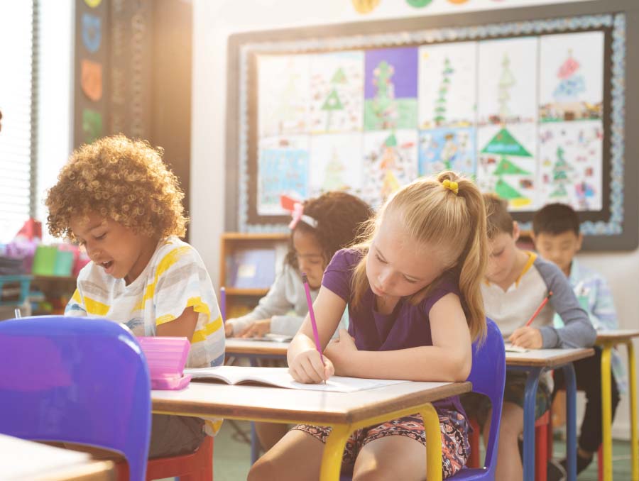 Children in their classroom writting