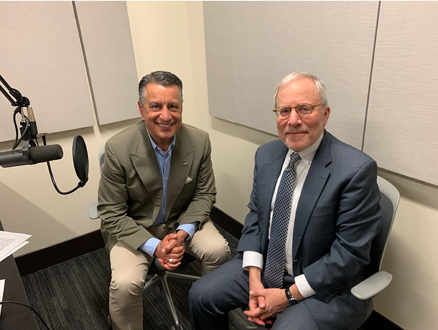 President Brian Sandoval sits next to Dr. Paul Hauptman in the podcasting room at the Reynold's School of Journalism.