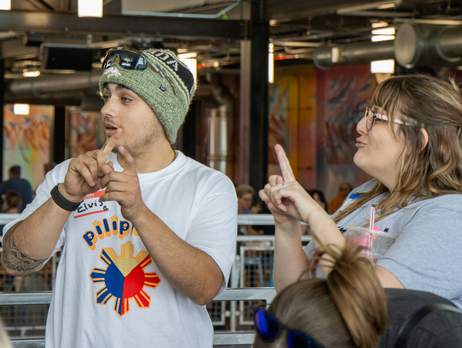 A man and a woman using sign language.