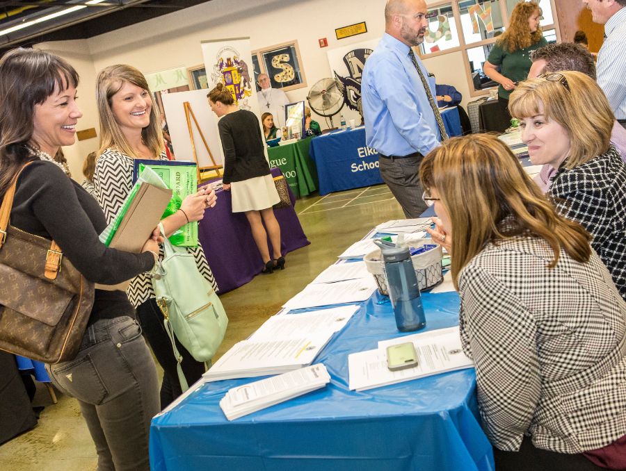 Students and employers talking at a career fair.