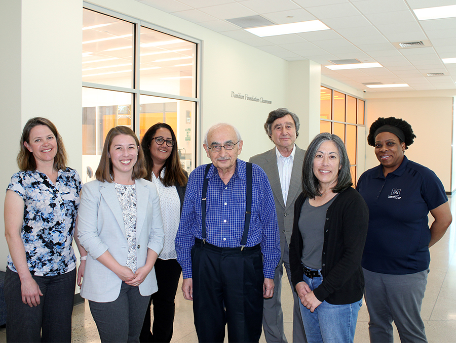 Seven people standing in a row inside the William Pennington Engineering Building.