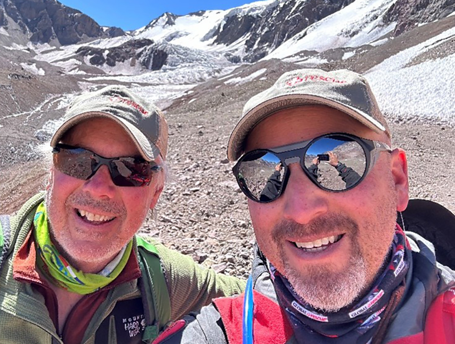 Eric Johnson and Arthur Islas taking a selfie with the Aconcagua Mountains in the background.