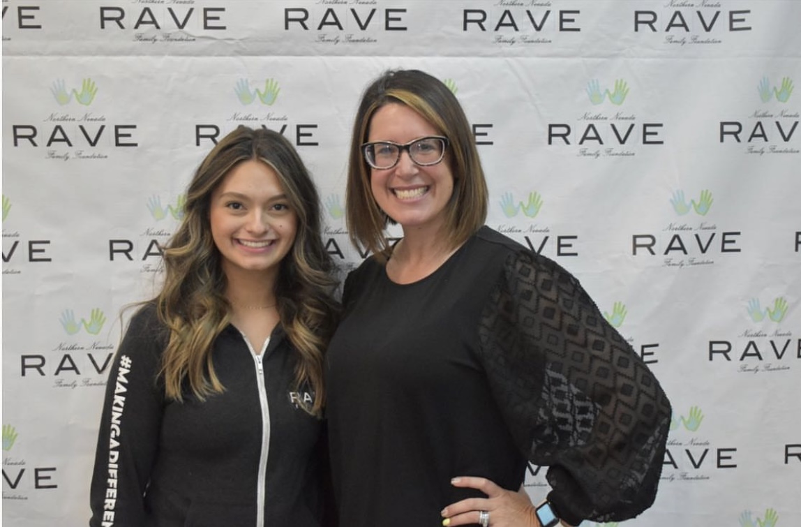 Jada and coworker in front of RAVE logoed backdrop