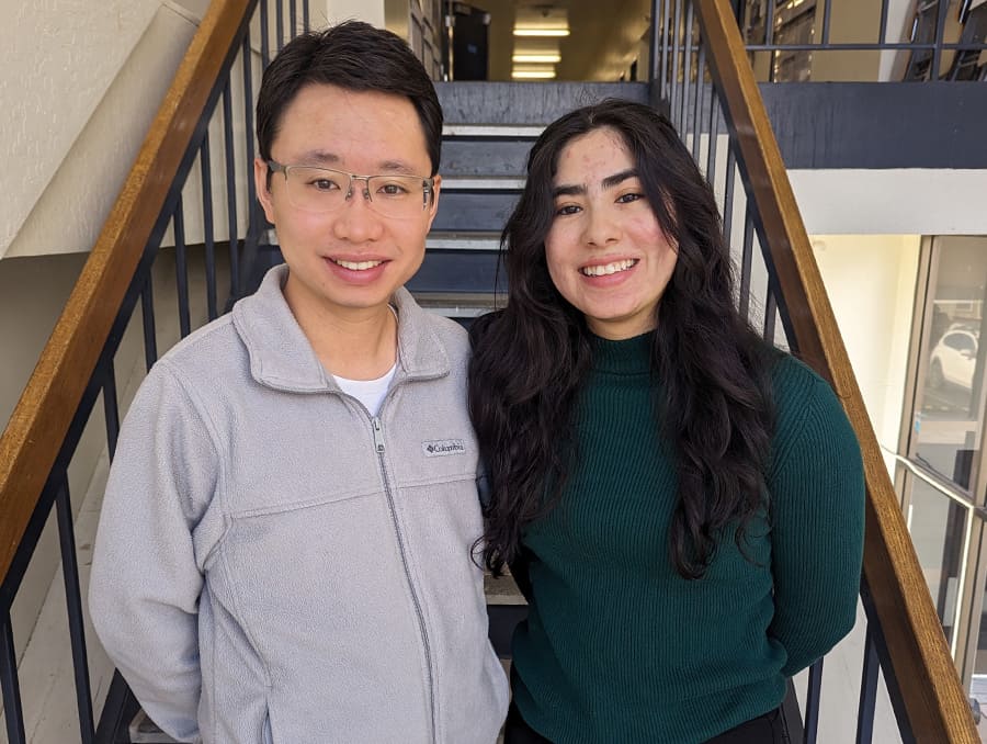 Assistant Professor Li Li standing next to student, Paola Miramontes on a stairwell.