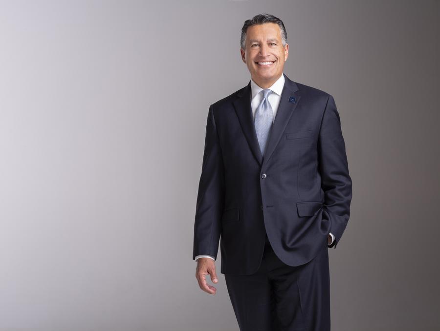 President Sandoval standing in front of a grey background.