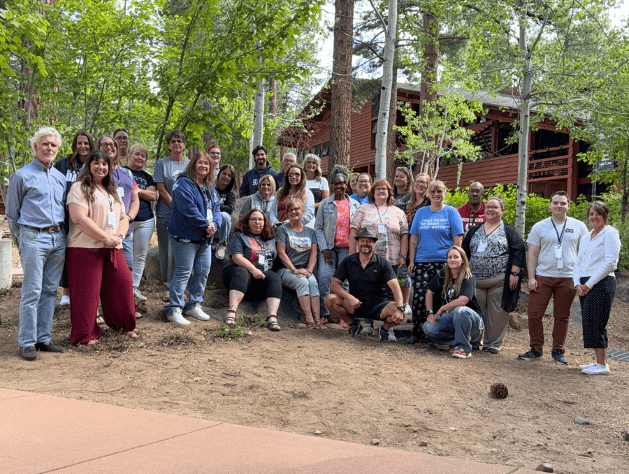 A group of people standing in front of a Lake Tahoe Campus building. 