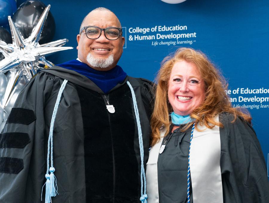 Jennifer and Dean Easton-Brooks in graduation attire.
