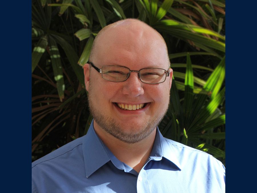 A smiling man poses for a picture.