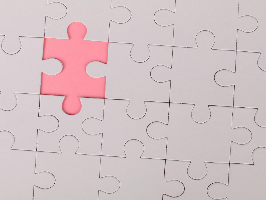 A blank puzzle with a piece missing. There is a pink shape where the piece is missing.