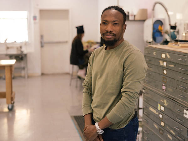 Jerry David posing in an art studio classroom.