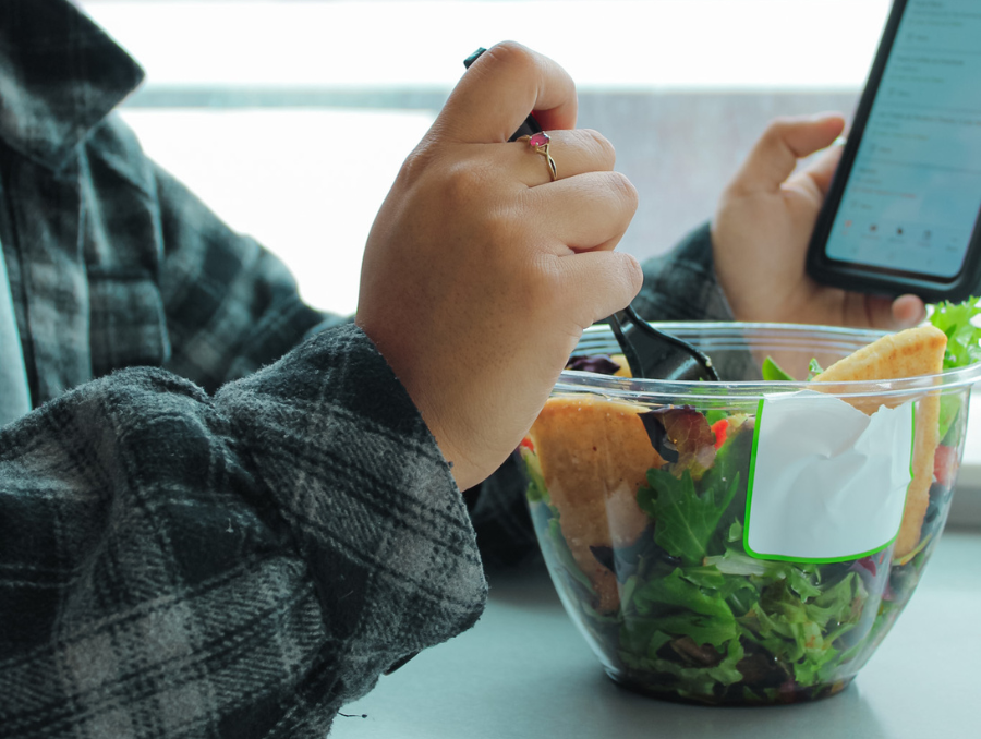 Student eating a salad inside the Overlook