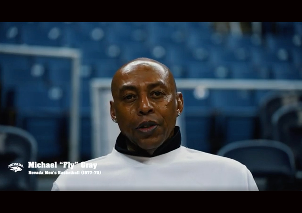 Screenshot of the video interview of Michael Gray. The Nevada Sport Wolf logo appears along with "Michael 'Fly' Gray. Nevada Men's Basketball (1977-79)"