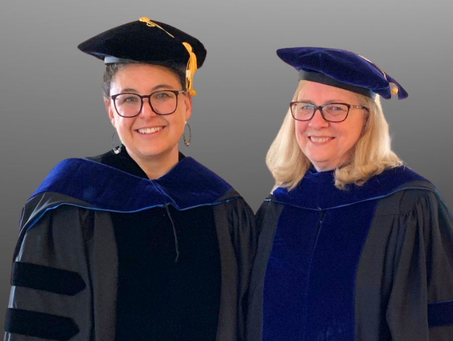 MaryAnn Demchak and Brianna Grumstrup wearing Ph.D. hooding regalia.