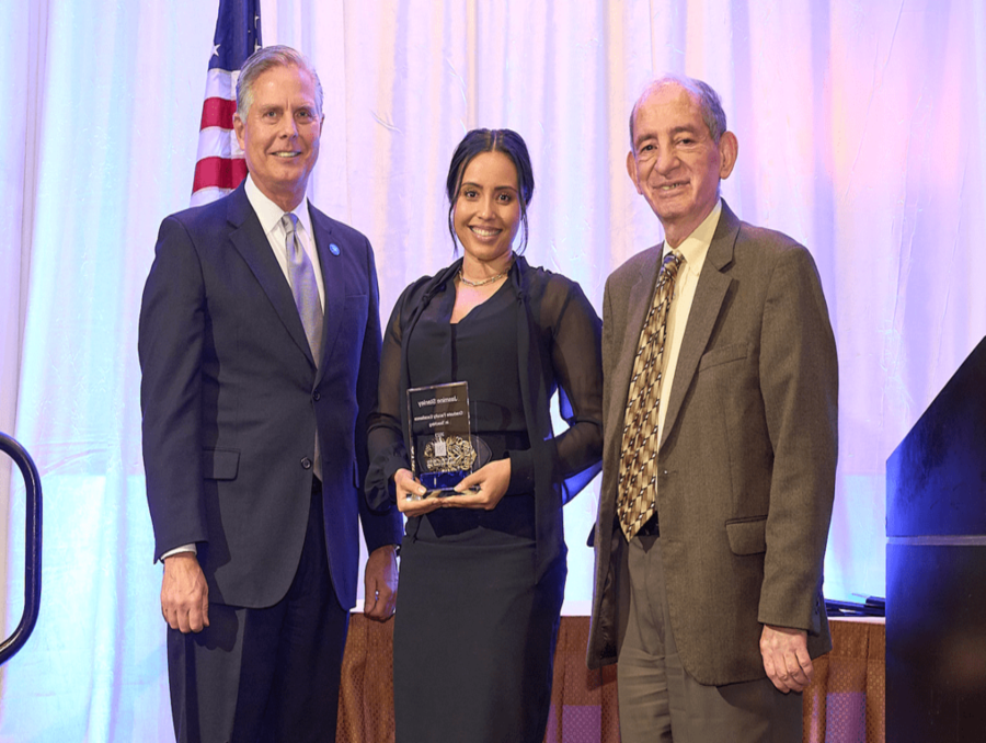 Jasmine Stanley receives a graduate faculty excellence in teaching award pictured with College of Business Dean Greg Mosier and Associate Dean Kambiz Raffiee.