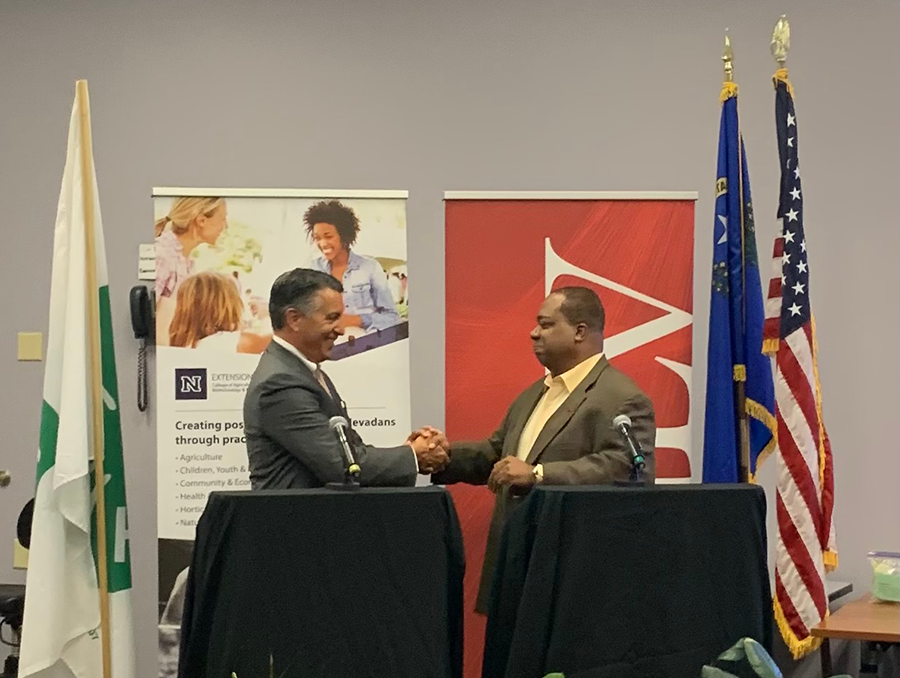 University of Nevada, Reno President Brian Sandoval and UNLV President Keith Whitfield shake hands.