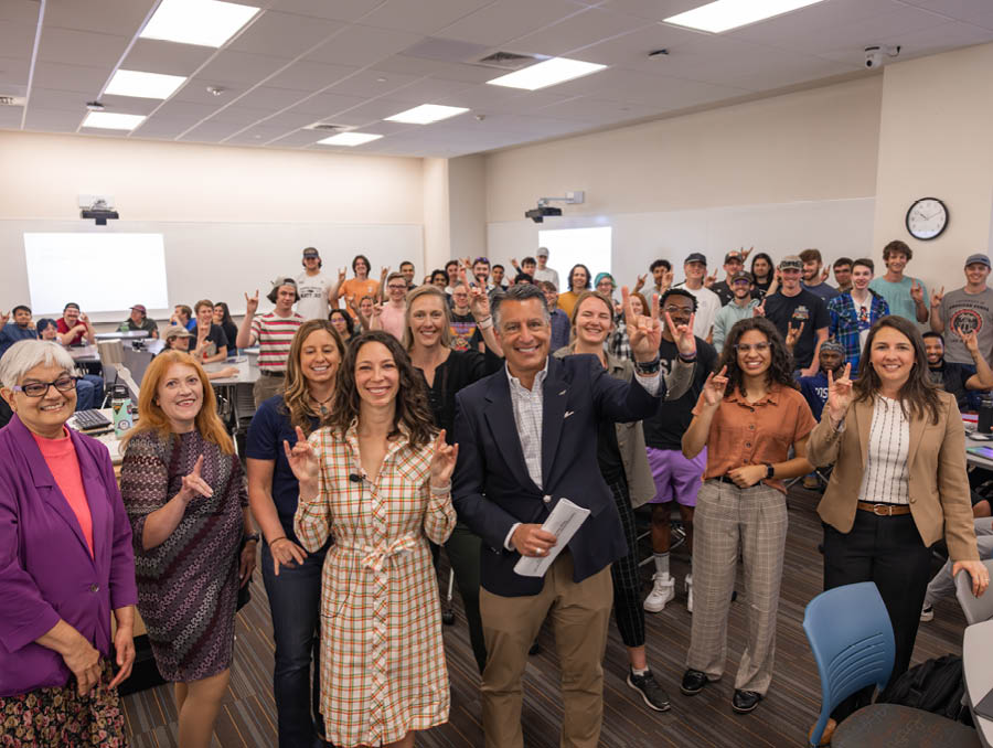 Kelly Keselica stands next to President Brian Sandoval and Department of Engineering faculty, staff and students.