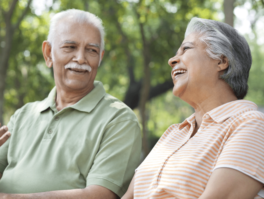 Two older adults laughing.