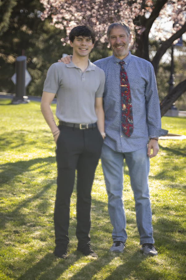 William and Dean standing outside on the quad.