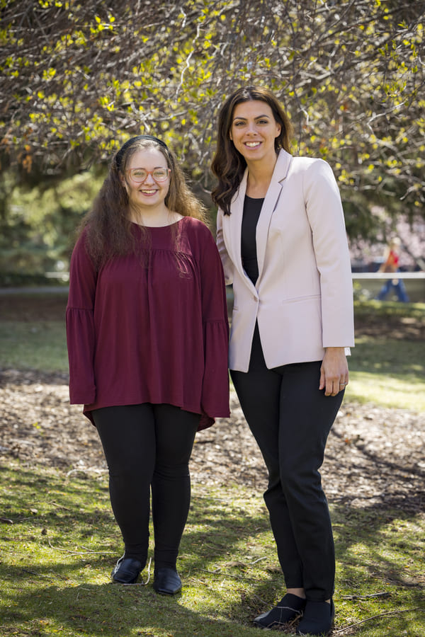 Taylor stands next to Marina outside on the quad.