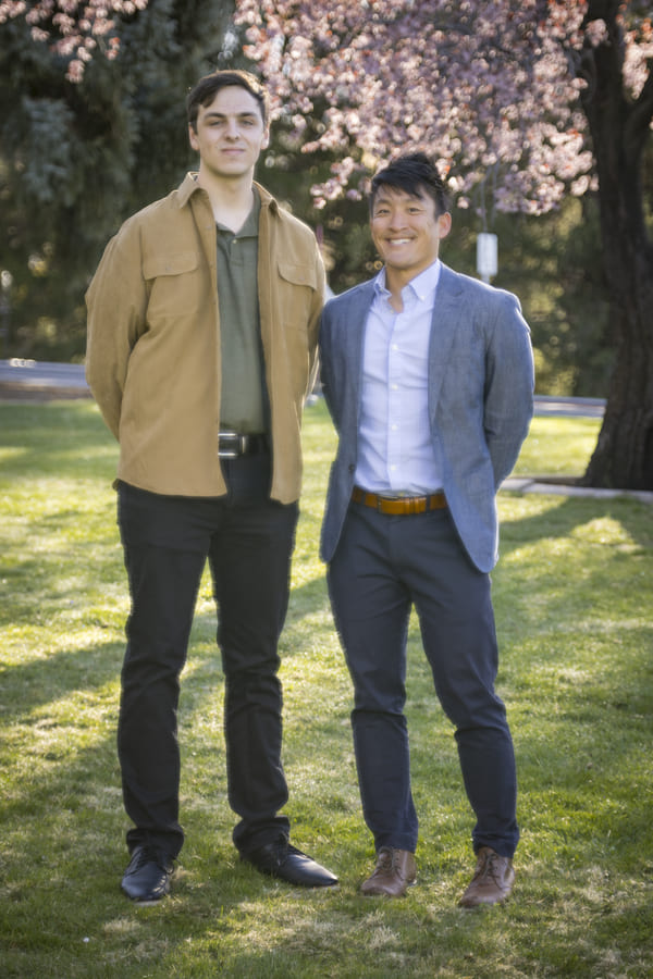 Jerod stands next to mentor Matthew outside on the quad.