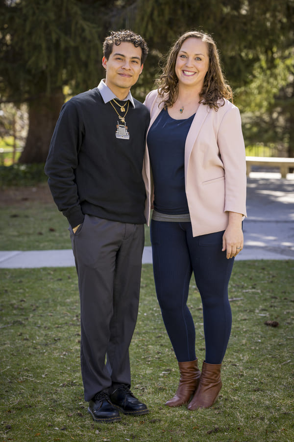 Boris stands next to mentor Jenna outside on the quad.