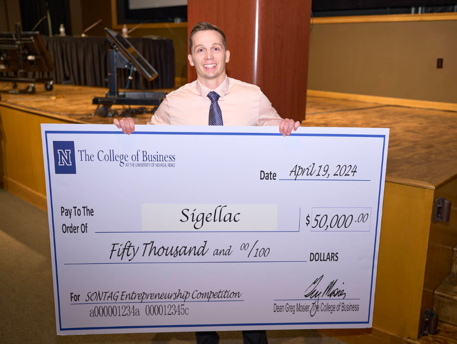 Sigellac representative holds a $50,000 check for winning Sontag competition