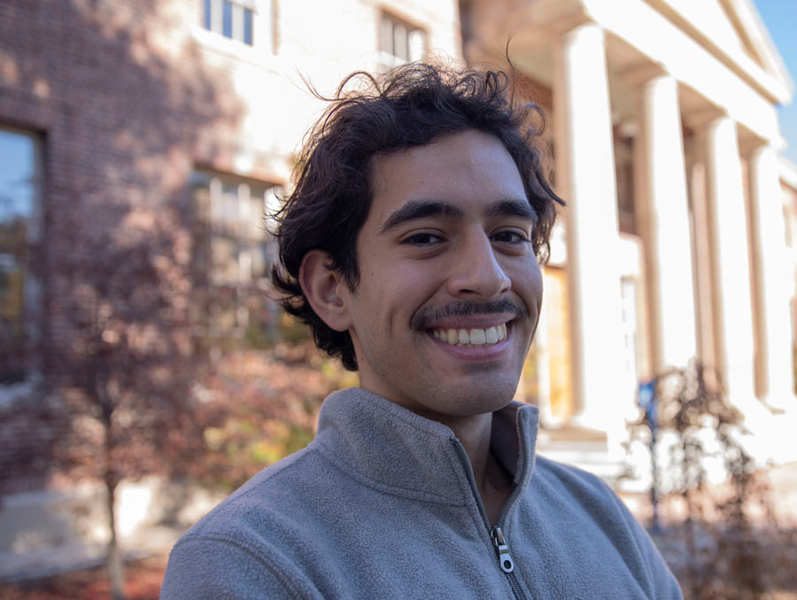 Jesus Diaz Sanchez smiles in front of the Mackay Mines building.