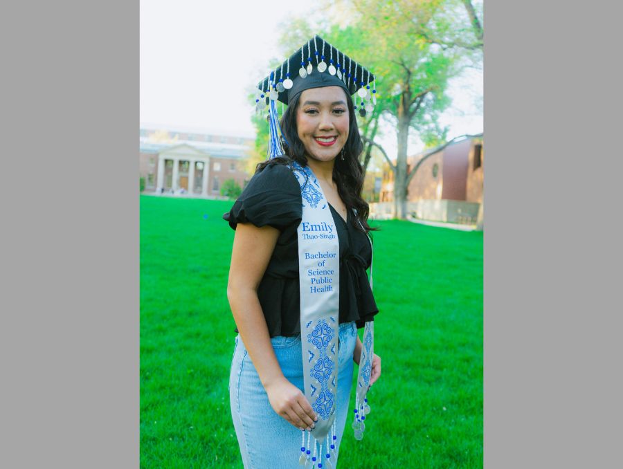 Emily Thao-Singh posing for her grad pictures on the quad.