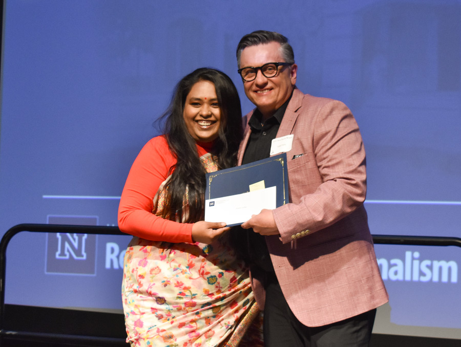 Jayanti Sarkar accepting and award certificate from Todd Felts. 