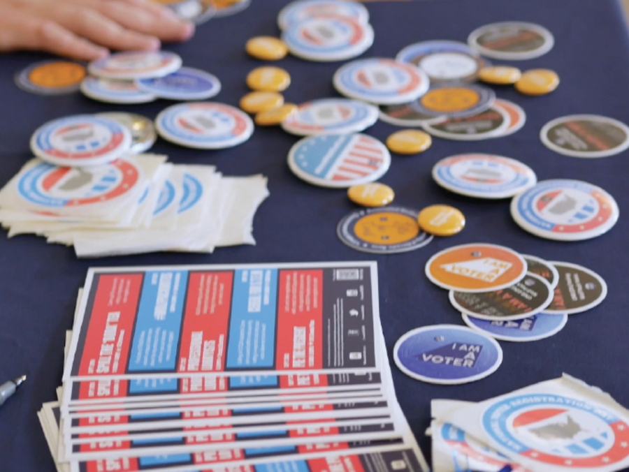 A blue political table hanging out flyers and stickers.