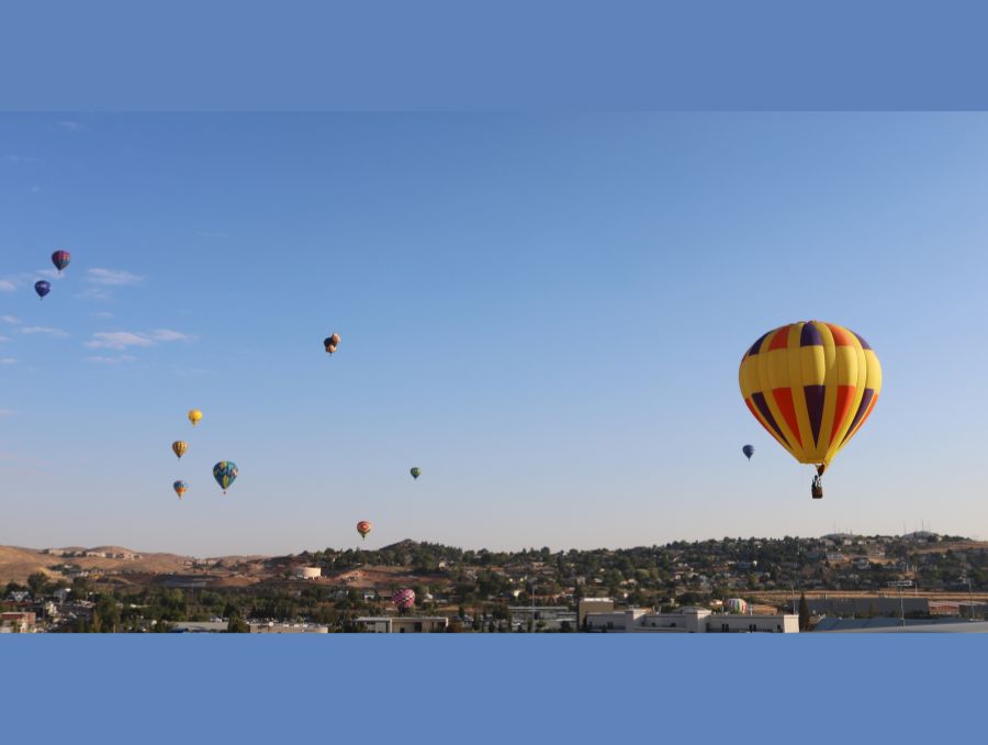 Hot air balloons scattered in the sky above Reno.